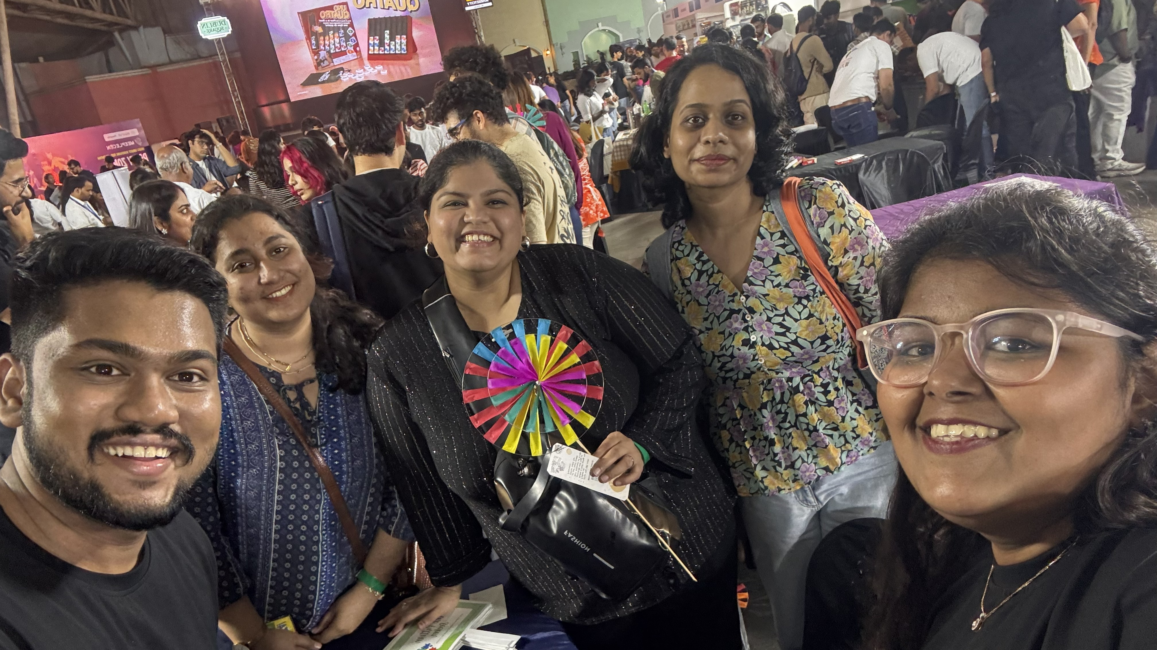 A large-scale live event scene with coordinated teams, active audience flow, and production control